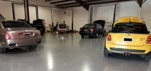Active Euroworks auto repair shop with a Rolls Royce, Mini, and BMWs being serviced.