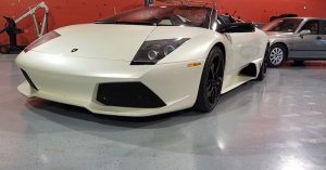Front-end photo taken of a pearl-white Lamborghini